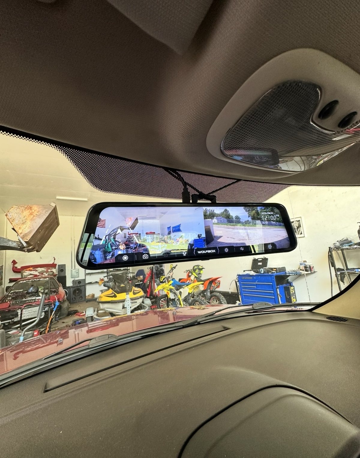 Wolfbox mirror dash cam installed, showing front and rear camera views