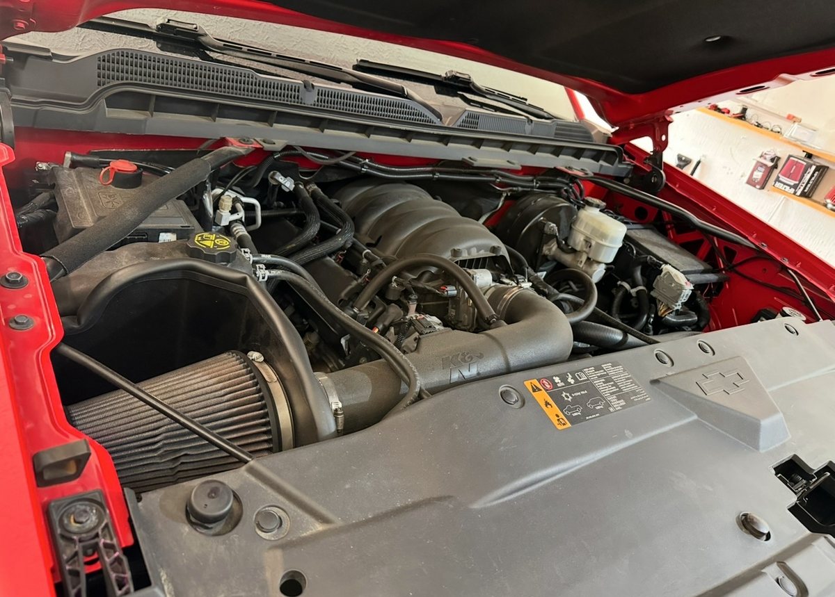Red Silverado engine bay with a K&N cold air intake installed