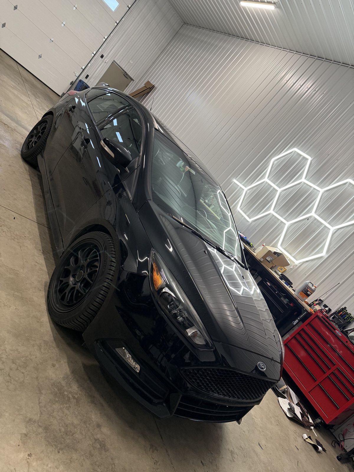 Black Ford Focus ST in the shop with a full window tint