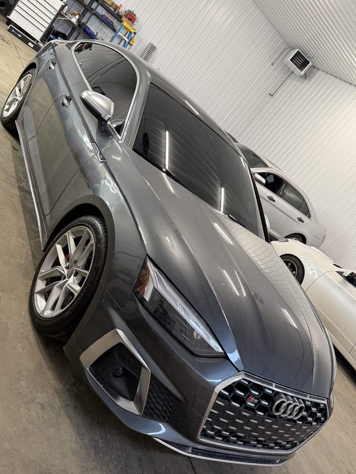 Grey Audi S5 Sportback after tint, front three-quarter view with dark glass