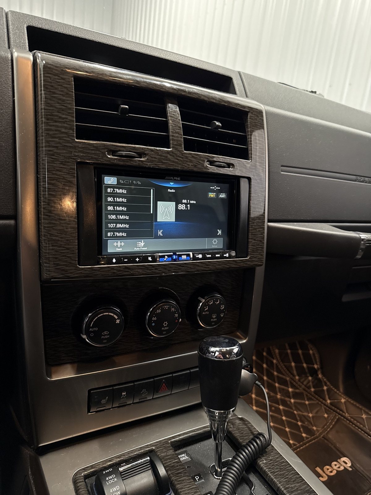Jeep Commander dash with an Alpine touchscreen head unit installed
