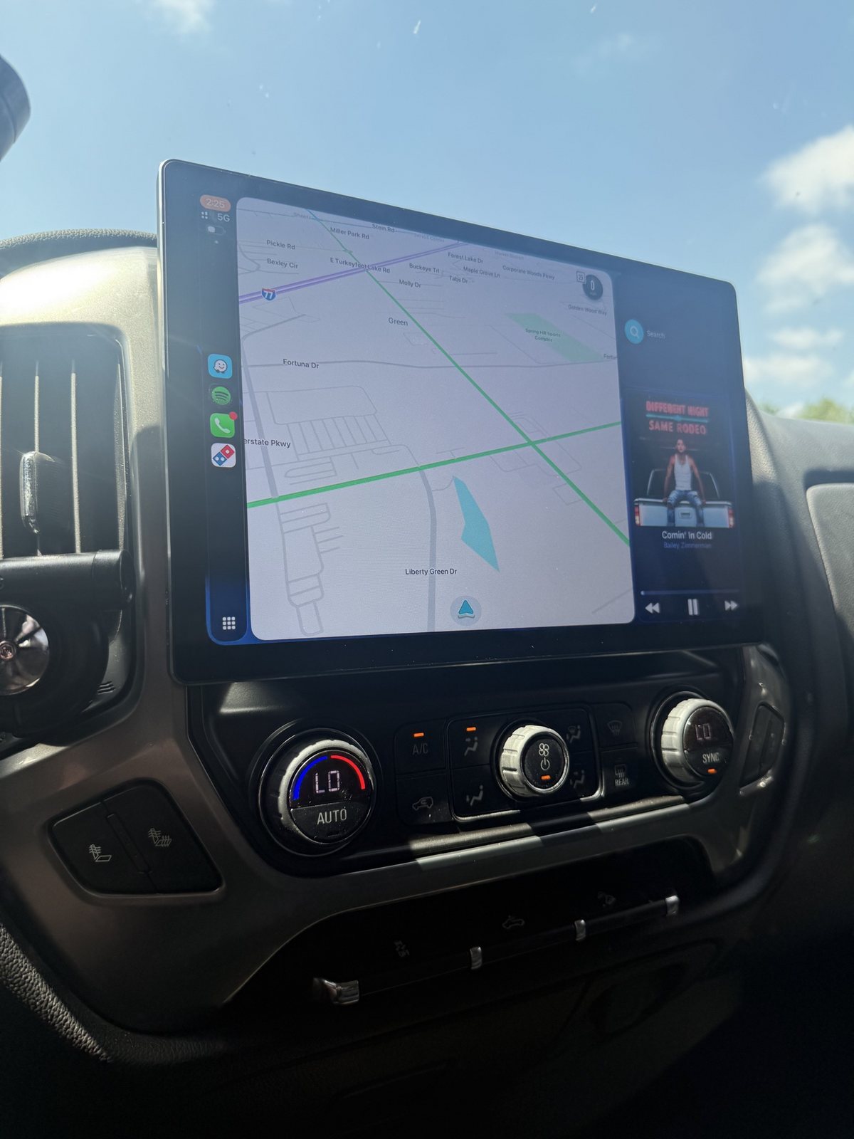 Large tablet-style head unit in a Silverado showing Apple CarPlay maps