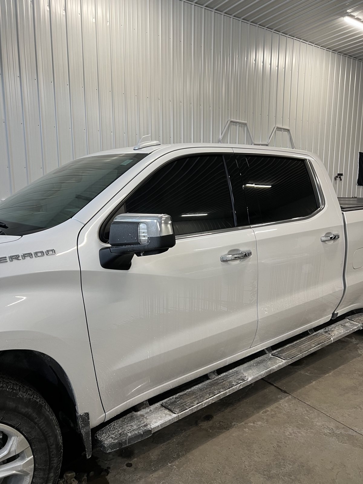 White Silverado crew cab after a full tint, all side glass dark