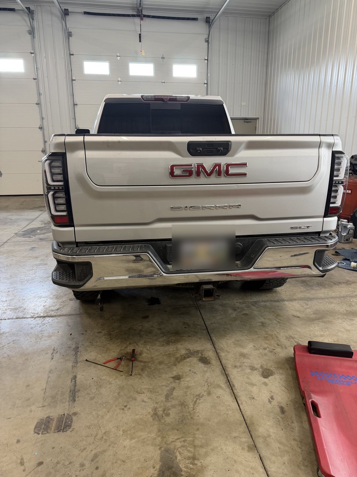 Silver GMC Sierra rear view with LED taillights installed in the shop