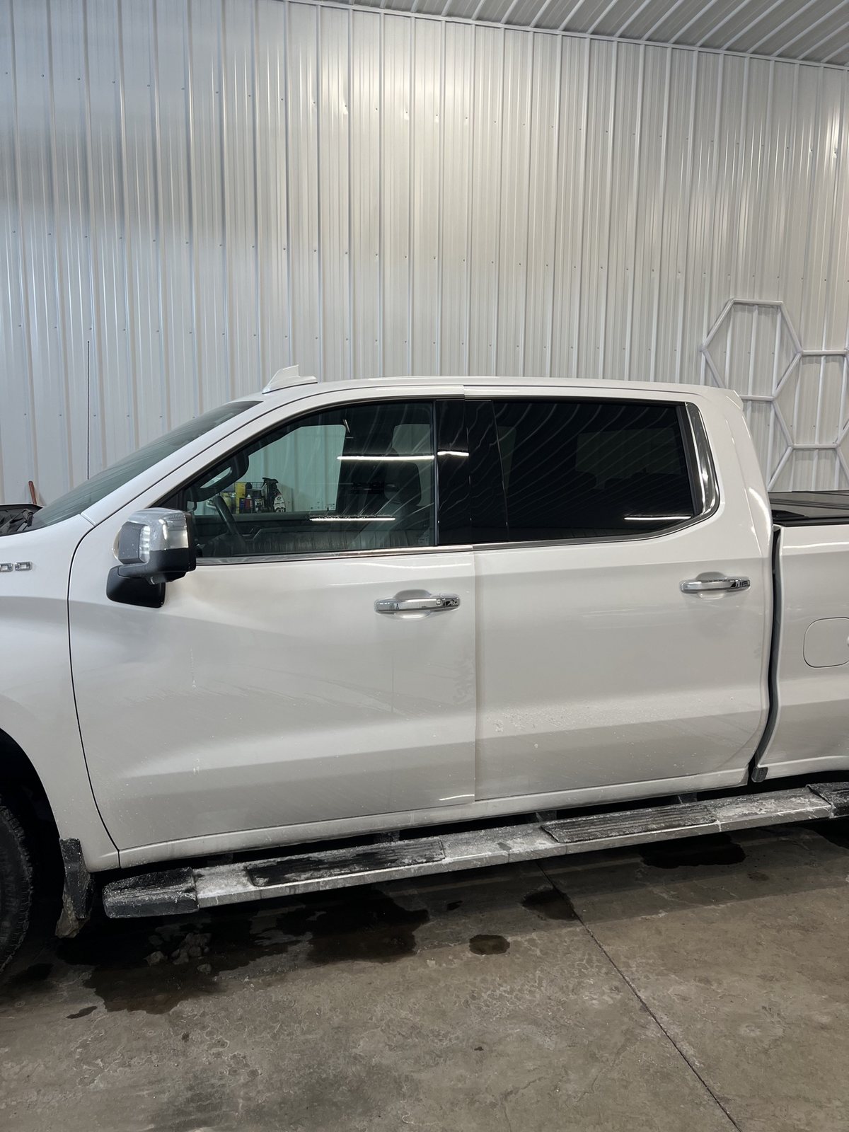 White Silverado crew cab before tint, front side glass still clear